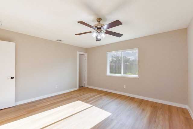 spare room featuring hardwood / wood-style floors and ceiling fan