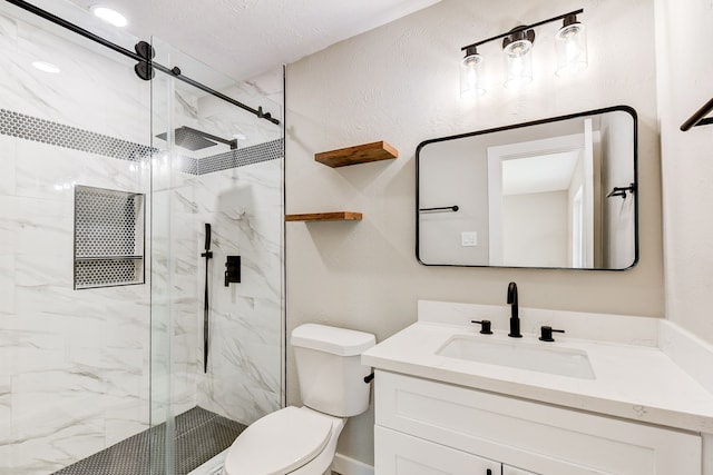 bathroom featuring vanity, an enclosed shower, a textured ceiling, and toilet