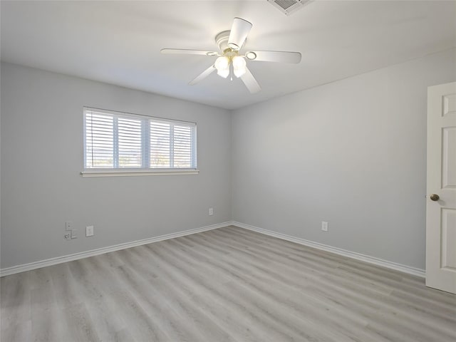 empty room with ceiling fan and light hardwood / wood-style flooring