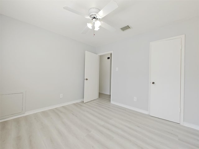 spare room with ceiling fan and light wood-type flooring