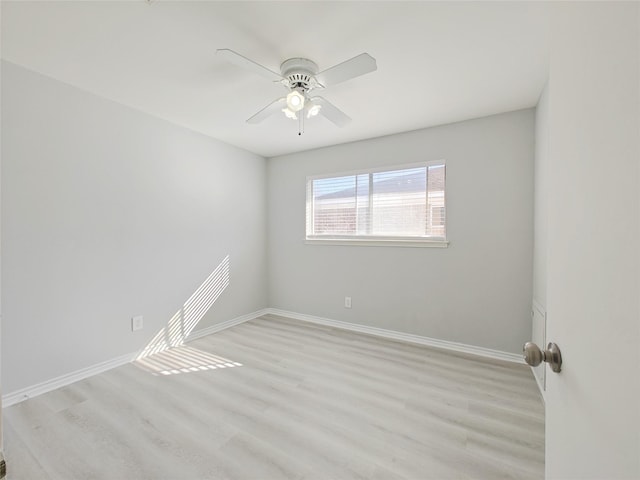 empty room with ceiling fan and light hardwood / wood-style floors