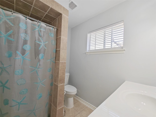 bathroom with tile patterned flooring, sink, a shower with curtain, and toilet