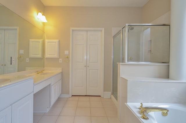 bathroom featuring tile patterned flooring, a sink, a closet, a shower stall, and double vanity