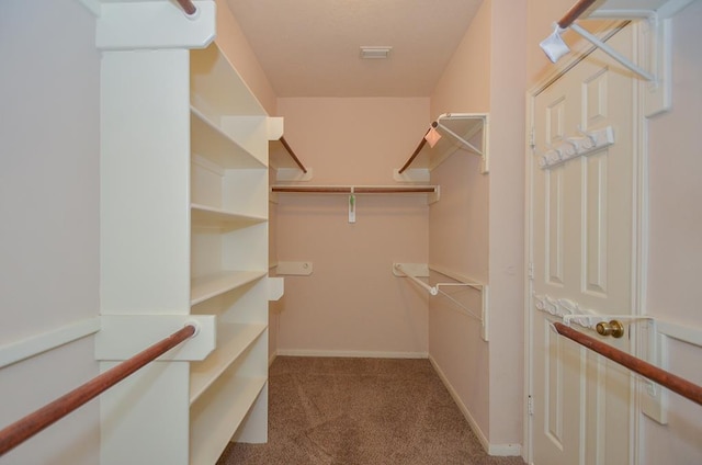 spacious closet with carpet flooring and visible vents