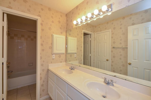 full bath with tile patterned floors, a sink, and wallpapered walls