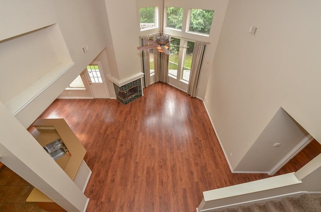 foyer featuring stairs, wood finished floors, a towering ceiling, and a wealth of natural light