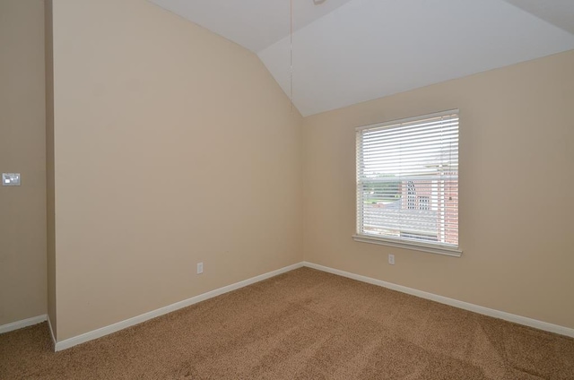 unfurnished room featuring vaulted ceiling, carpet, and baseboards