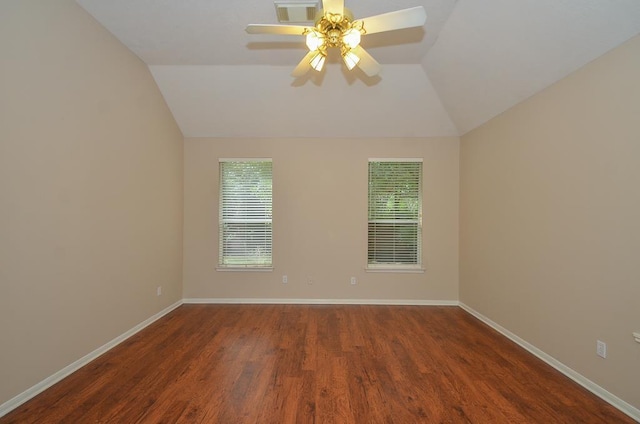 unfurnished room featuring lofted ceiling, baseboards, visible vents, and dark wood finished floors