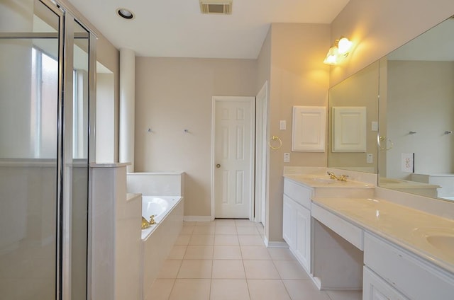 bathroom featuring visible vents, double vanity, tile patterned flooring, and a bath