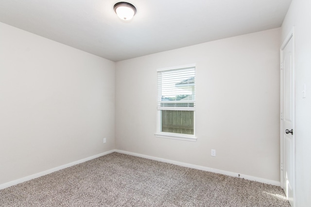 spare room with carpet flooring and baseboards