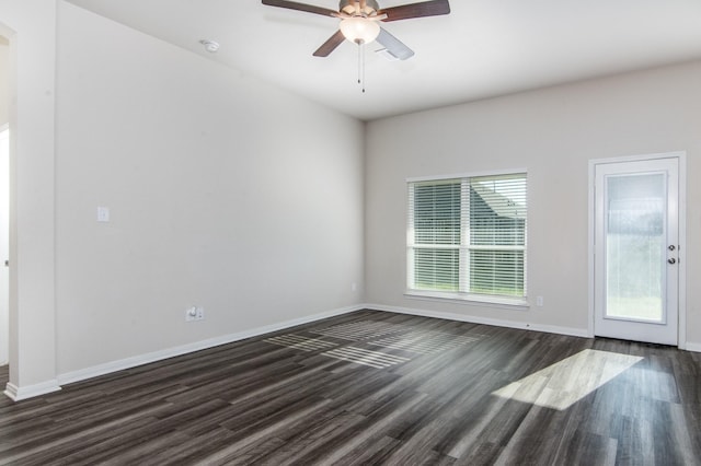 unfurnished room featuring ceiling fan, dark wood-type flooring, and baseboards