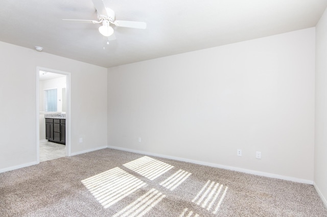 unfurnished room featuring light carpet, ceiling fan, and baseboards