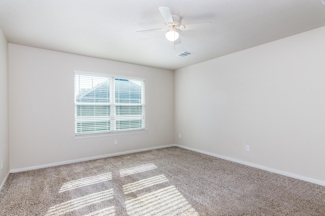 empty room featuring baseboards, carpet, visible vents, and a ceiling fan