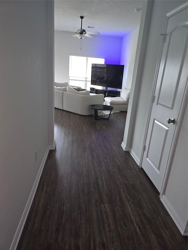 interior space featuring baseboards and dark wood-style flooring