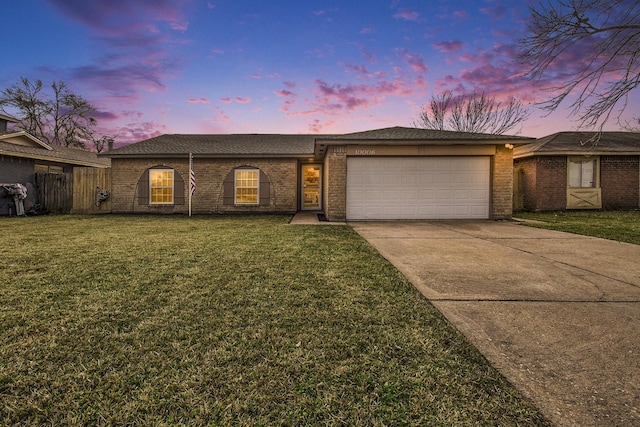 single story home featuring a yard and a garage