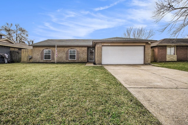 single story home with a garage and a front lawn