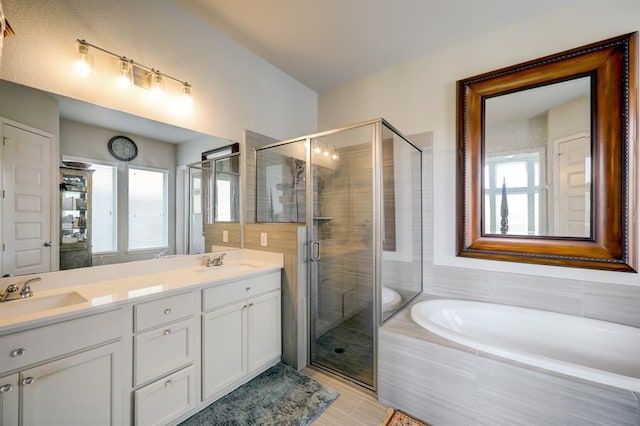 bathroom with vanity and independent shower and bath