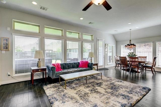 living room featuring lofted ceiling, dark hardwood / wood-style floors, and ceiling fan with notable chandelier