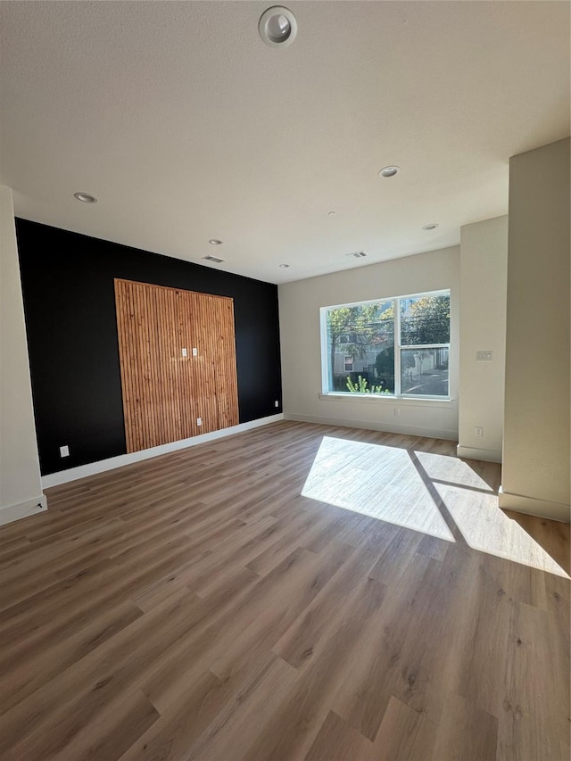 empty room with wood-type flooring