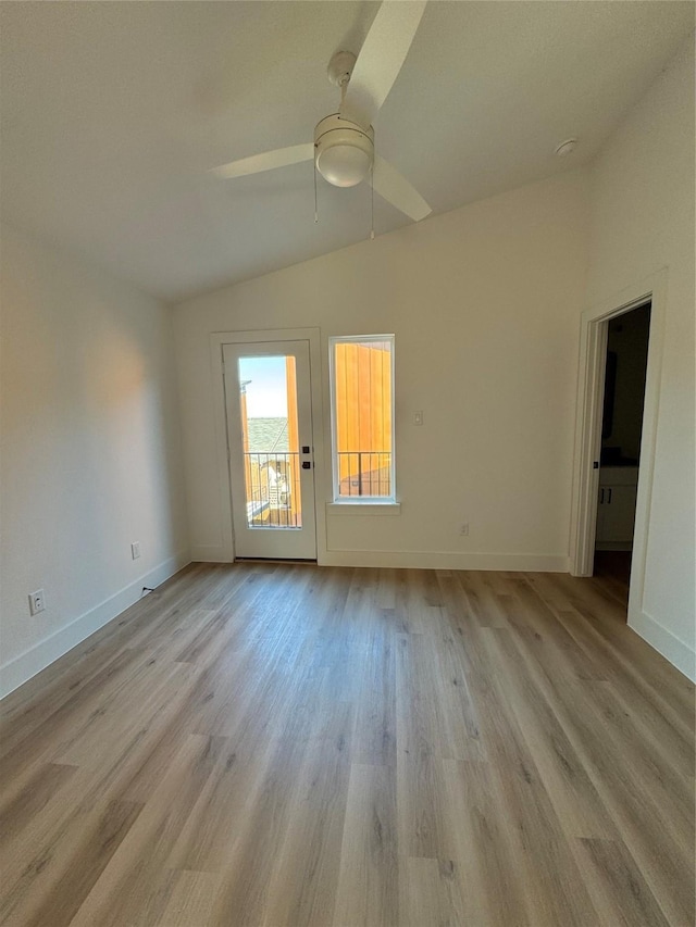 empty room featuring vaulted ceiling, ceiling fan, and light wood-type flooring