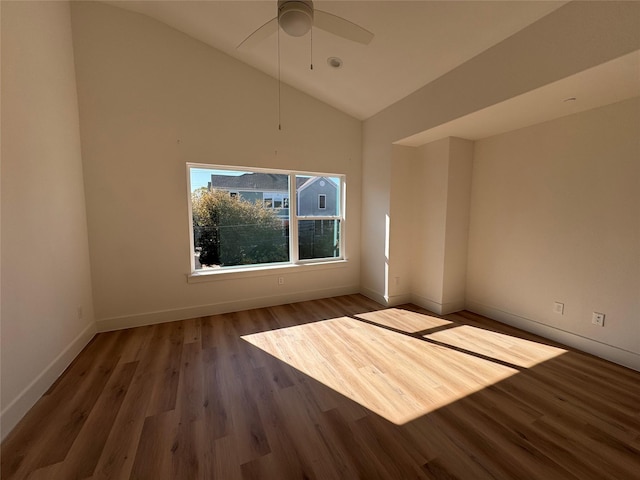 unfurnished room with dark hardwood / wood-style flooring, vaulted ceiling, and ceiling fan