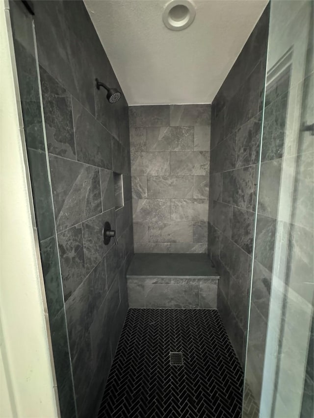 bathroom with tiled shower