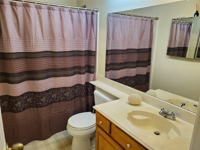 bathroom with a shower with curtain, vanity, toilet, and tile patterned floors