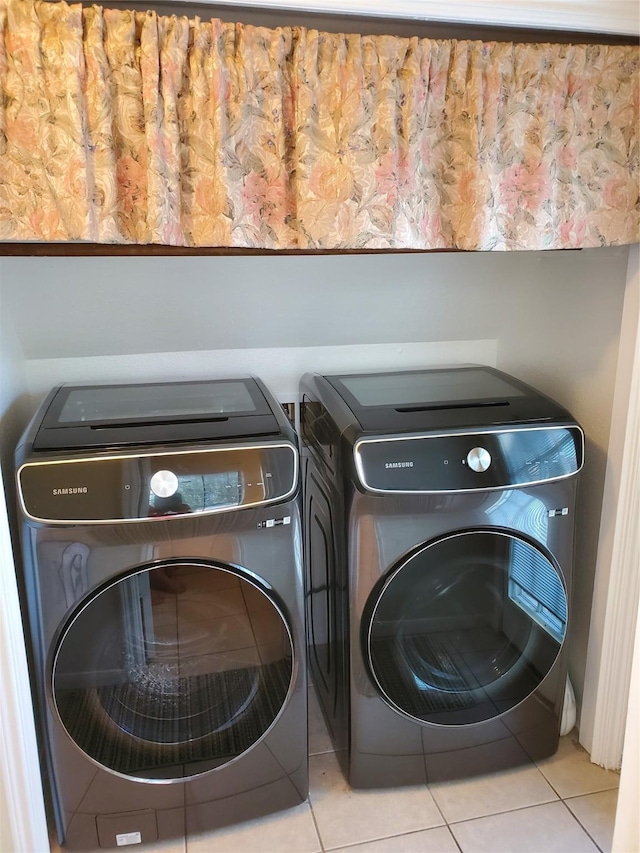 laundry room with washing machine and dryer, laundry area, and tile patterned flooring