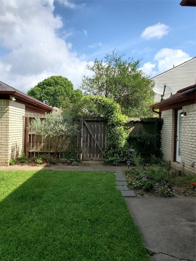 view of yard with a gate and fence