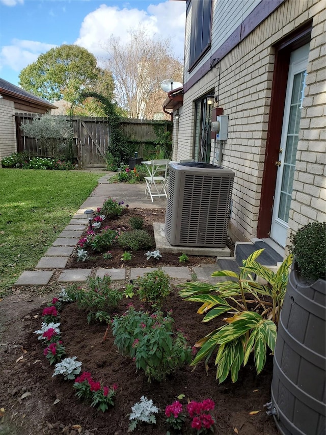 view of yard featuring a patio, central AC unit, and fence