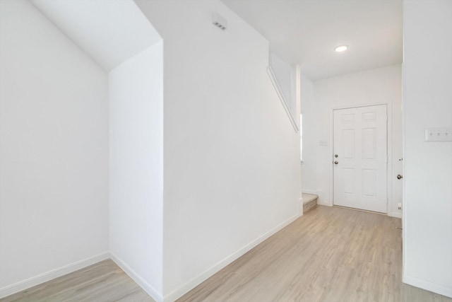 corridor featuring recessed lighting, light wood-style flooring, and baseboards