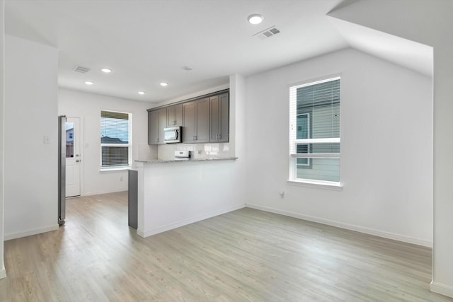 kitchen with visible vents, stainless steel microwave, light wood-style flooring, and recessed lighting