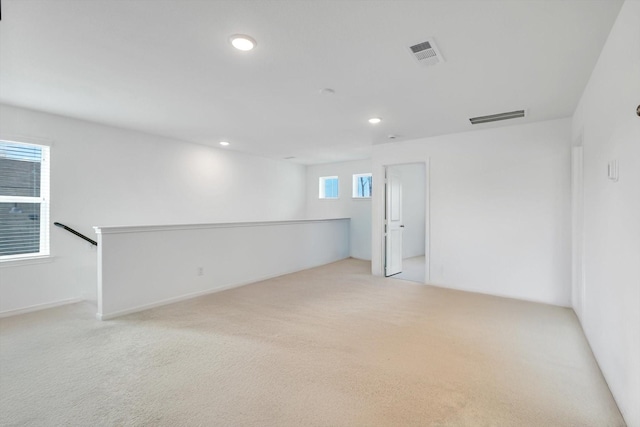 unfurnished room with visible vents, carpet flooring, and recessed lighting