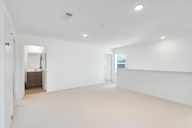 unfurnished room with recessed lighting, visible vents, and light colored carpet