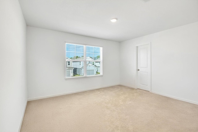 empty room with light carpet and baseboards