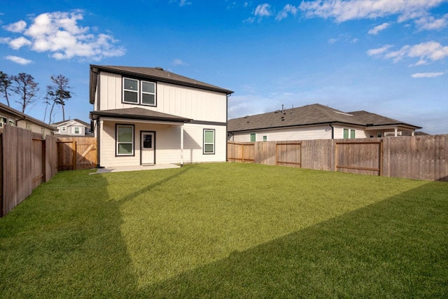 back of house with a patio area, a fenced backyard, and a yard