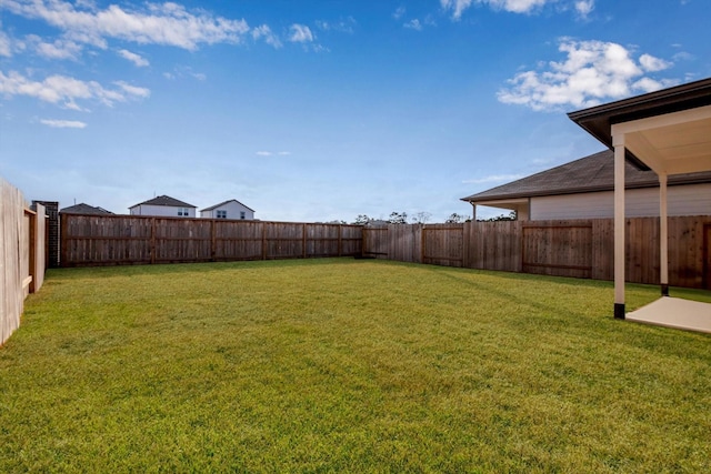 view of yard with a fenced backyard