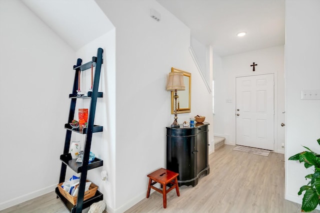 foyer entrance featuring light wood-type flooring, stairway, baseboards, and recessed lighting