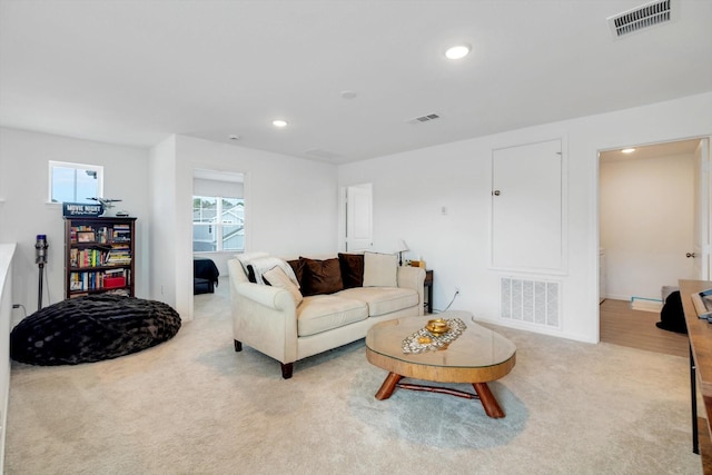 living room featuring carpet, visible vents, and recessed lighting