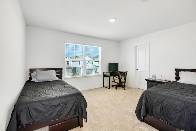 bedroom with baseboards and light colored carpet