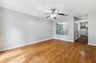 unfurnished living room featuring dark hardwood / wood-style floors and ceiling fan