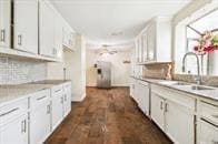 kitchen with dark hardwood / wood-style floors, sink, decorative backsplash, and white cabinets