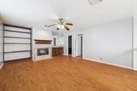 unfurnished living room with wood-type flooring