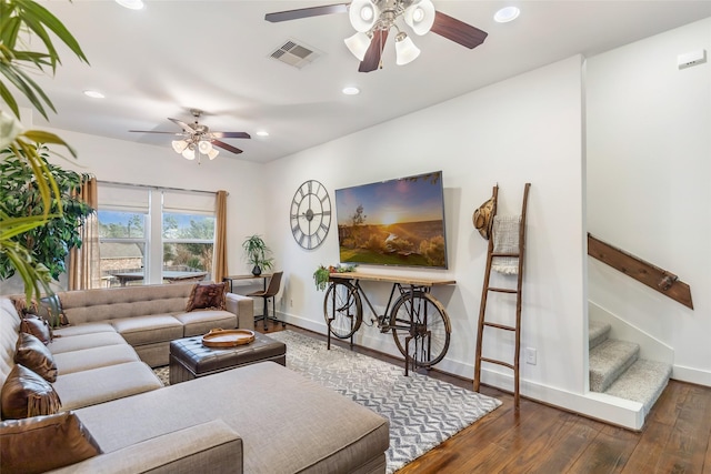 living room featuring dark wood-type flooring and ceiling fan