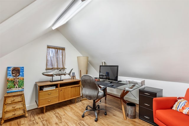 office with lofted ceiling and light wood-type flooring