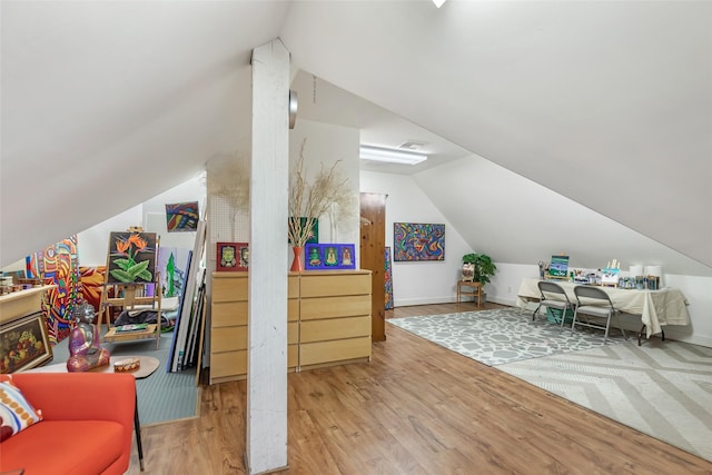 interior space with lofted ceiling and hardwood / wood-style floors