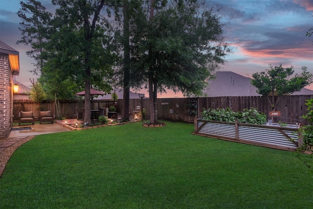 yard at dusk with a patio