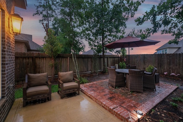 view of patio terrace at dusk