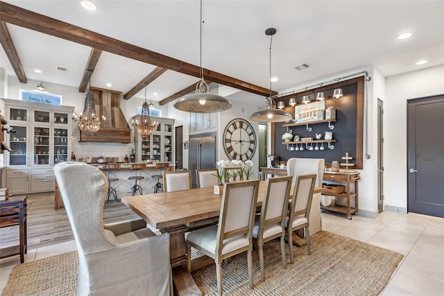 dining room with beamed ceiling and light tile patterned floors