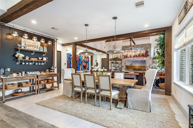 tiled dining room featuring beamed ceiling